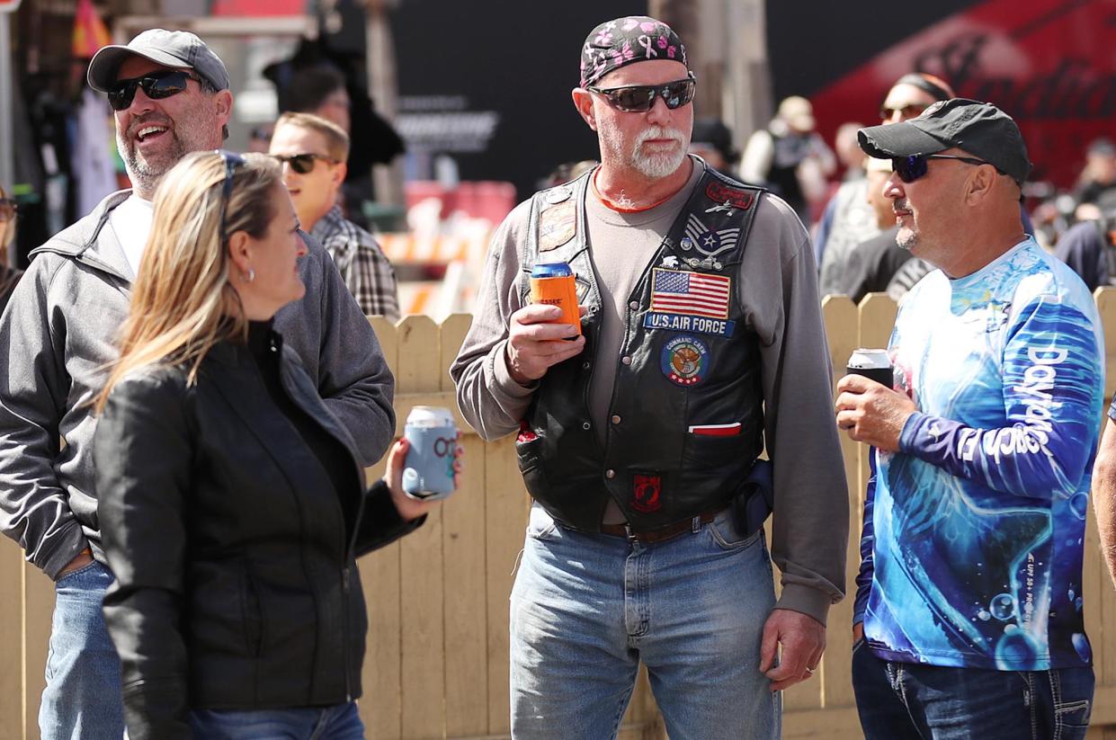 Biker enthusiasts enjoy cold beers on Main Street during Bike Week in Daytona Beach on Monday, March 8, 2021. (Stephen M. Dowell/Orlando Sentinel)