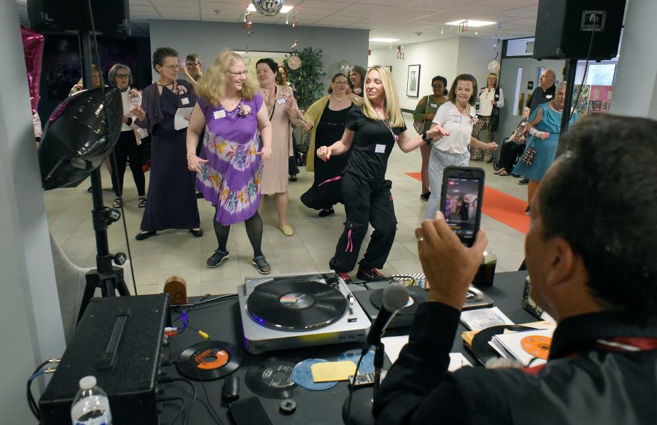 The DJ, Maj. Wayne Ruston of the Salvation Army in Monroe, enjoyed playing his oldies, vinyl 45s and LPs, as dance instructor Laura Macaluso-Hunt (in black) leads the way  June 2 at the senior prom at the Mable H. Kehres apartments in Monroe.