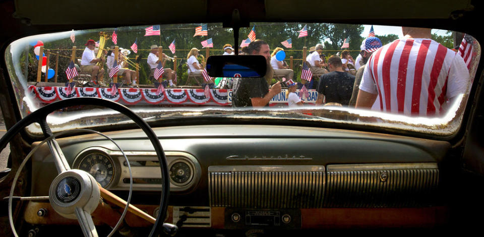 Members of the St. Charles Municipal Band roll past a 1953 Chevy on the lot of McNeil Motor Cars as the St. Charles Jaycees Riverfest Parade makes its way through the Frenchtown neighborhood on Tuesday, July 4. (Photo: Photo by Robert Cohen/St. Louis Post-Dispatch)
