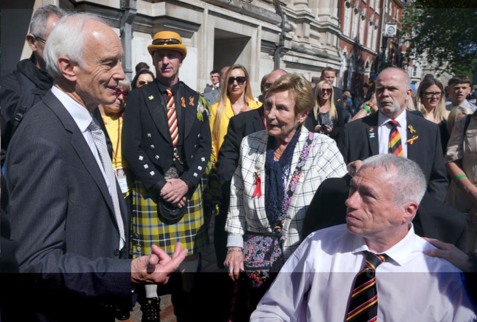 Chairman of the infected blood inquiry Sir Brian Langstaff with victims and campaigners outside Central Hall (Jeff Moore/PA Wire)