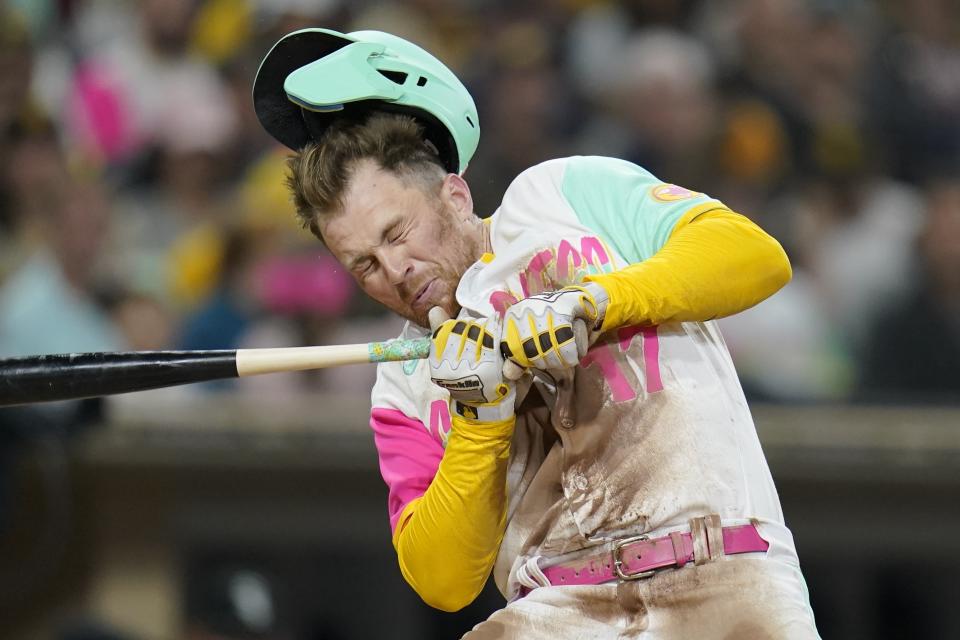 San Diego Padres' Brandon Drury is hit in the helmet by a pitch during the fourth inning of a baseball game against the Chicago White Sox, Friday, Sept. 30, 2022, in San Diego. (AP Photo/Gregory Bull)