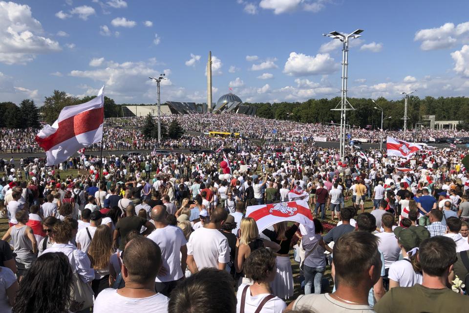 Belarusian opposition supporters rally in the center of Minsk, Belarus, Sunday, Aug. 16, 2020. Opposition supporters whose protests have convulsed the country for a week aim to hold a major march in the capital of Belarus. Protests began late on Aug. 9 at the closing of presidential elections. (AP Photo/Sergei Grits)