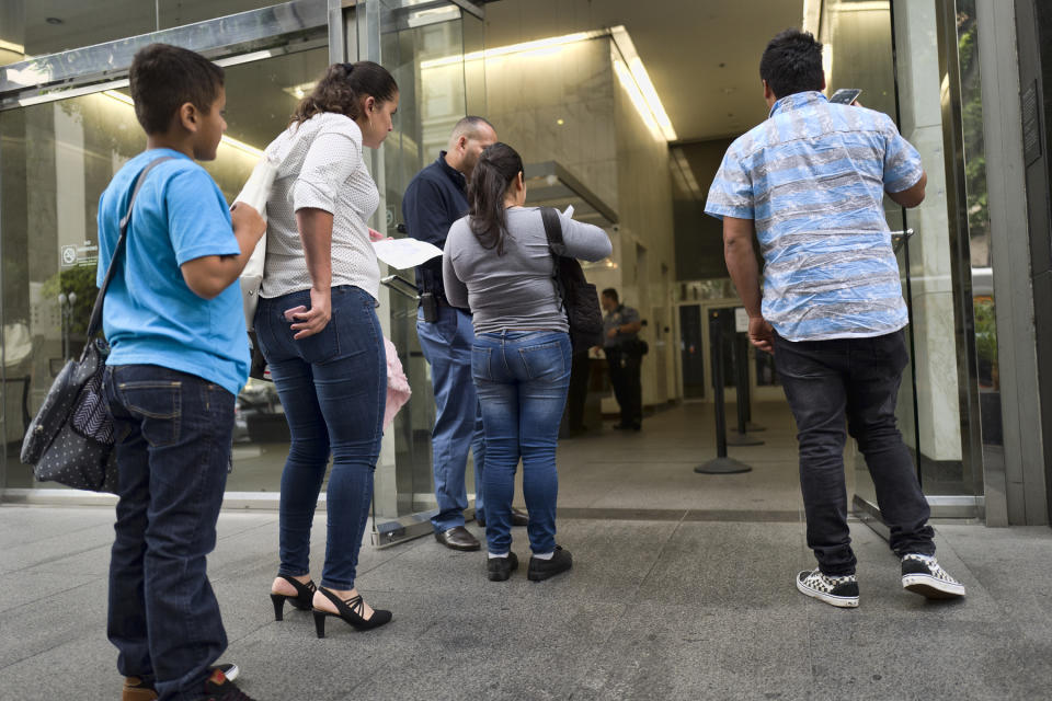 In this May 30, 2019, photo, people line up to enter immigration court in downtown Los Angeles. The Trump administration has appointed more than 4 in 10 of the country’s sitting immigration judges in a hiring surge that comes as U.S. authorities seek to crack down on immigration. (AP Photo/Richard Vogel)
