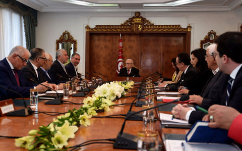 Tunisian President Beji Caid Essebsi (C) attends a meeting with political parties, unions and employers following unrest triggered by austerity measures - Credit: FETHI BELAID/AFP