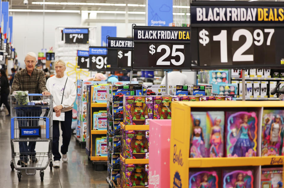 signs inside of a Walmart advertising Black Friday deals