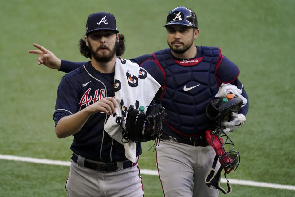 Atlanta Braves starting pitcher Ian Anderson and catcher Travis d'Arnaud walk to the dugout before Game 2 of a baseball National League Championship Series against the Los Angeles Dodgers Tuesday, Oct. 13, 2020, in Arlington, Texas. (AP Photo/Tony Gutierrez)