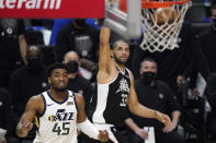 Los Angeles Clippers forward Nicolas Batum, right, scores as Utah Jazz guard Donovan Mitchell watches during the second half in Game 6 of a second-round NBA basketball playoff series Friday, June 18, 2021, in Los Angeles. (AP Photo/Mark J. Terrill)