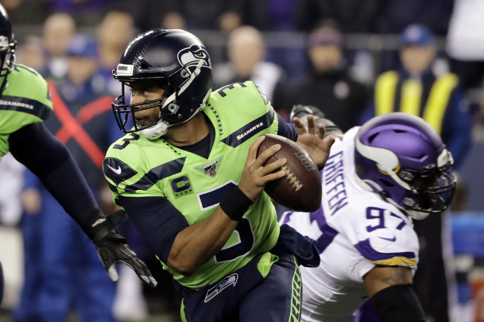 Russell Wilson's magic backfired with a bizarre pick six against the Vikings. (Ted S. Warren/AP)