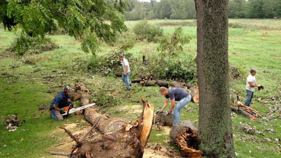 Pictured left to right are: Vance Glewen, Mike Dull, Doug Shotsky, and Randy Witchow in the cleanup from a tornado in Wisconsin.