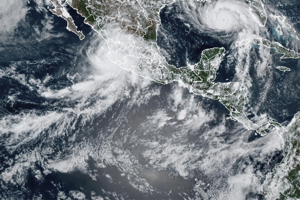 This image provided by the National Oceanic and Atmospheric Administration (NOAA) shows severe weather systems, Hurricane Nora, upper left, and Hurricane Ida, upper right, over the North American continent on Saturday, Aug. 28, 2021. Hurricane Nora is churning northward up Mexico's Pacific Coast toward the narrow Gulf of California, after making a sweep past the Puerto Vallarta area. (NOAA via AP)