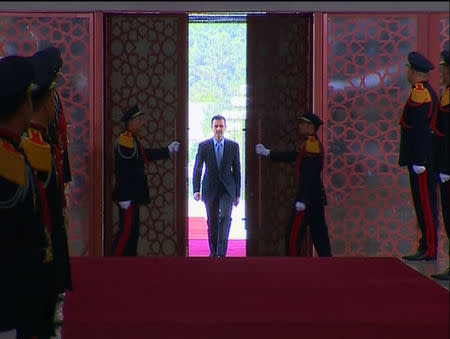 A still image taken from video shows Syria's President Bashar al-Assad arriving to be sworn in for a new seven-year term at the presidential palace in Damascus July 16, 2014. REUTERS/Syria TV via Reuters TV