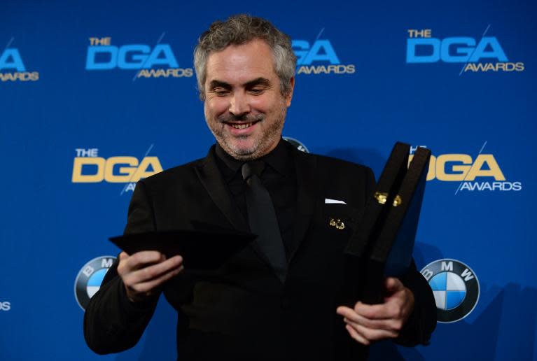 Mexican film director Alfonso Cuaron holds his trophy For Outstanding Directorial Achievement in Feature Film "Gravity" in the press room at the 66th Annual Directors Guild of America Awards January 25, 2014 in Century City, California