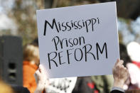 Several attendees waved handmade posters calling for help for the inmates during a mass rally in front of the Mississippi Capitol in Jackson, Miss., Friday, Jan. 24, 2020, protesting conditions in prisons where inmates have been killed in violent clashes in recent weeks. (AP Photo/Rogelio V. Solis)