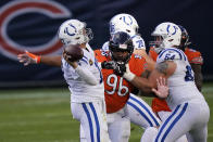 Indianapolis Colts quarterback Philip Rivers (17) throws while being pressured by Chicago Bears' Akiem Hicks (96) during the first half of an NFL football game Sunday, Oct. 4, 2020, in Chicago. (AP Photo/Charles Rex Arbogast)