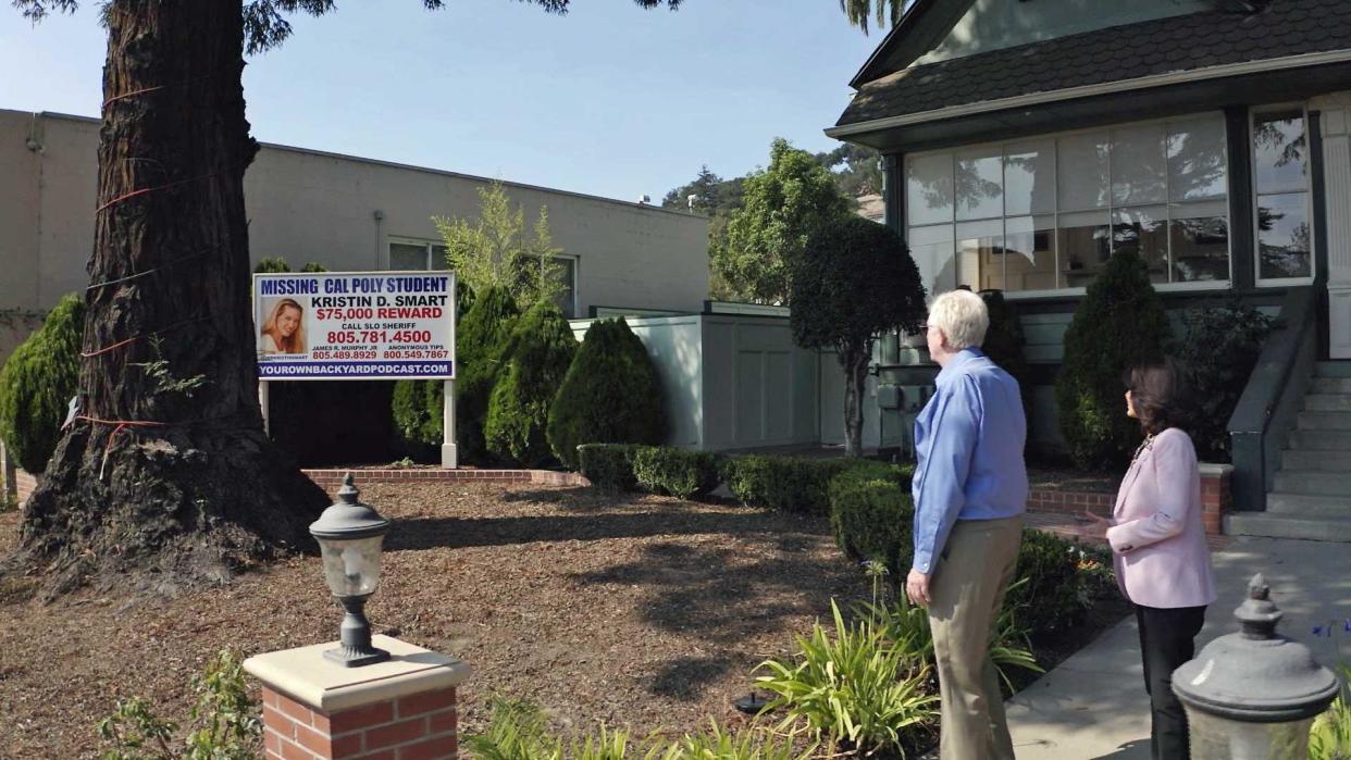 James Murphy and Garin Sinclair look at the billboard that has been in their front yard for more than two decades. They believe they can prove Paul Flores is responsible for the disappearance of Kristin Smart. / Credit: CBS News