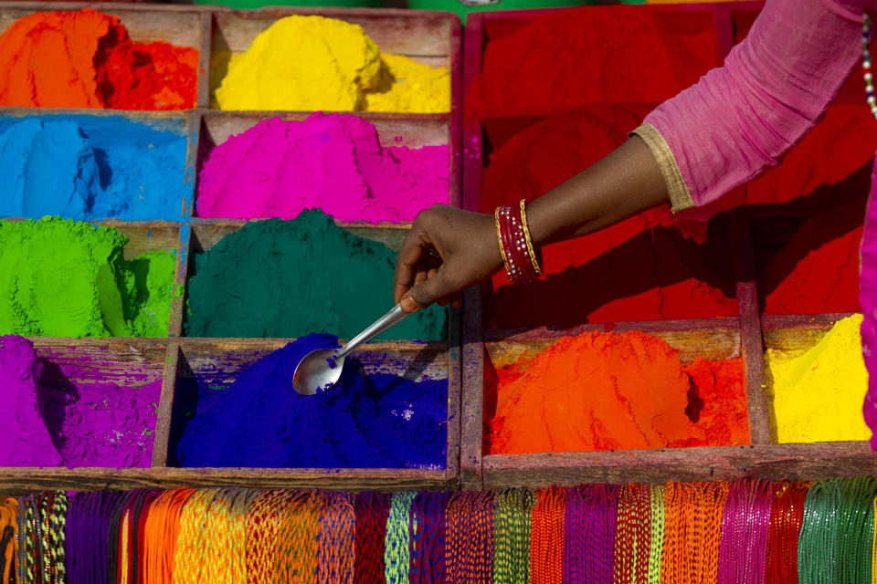 In this Wednesday, Nov. 7, 2018, file photo, a Nepalese vendor sells powder during Tihar festival in Kathmandu, Nepal. Hindus decorate their houses and worship, Lakshmi, the goddess of wealth during the Tihar festival. (AP Photo/Niranjan Shrestha, File)