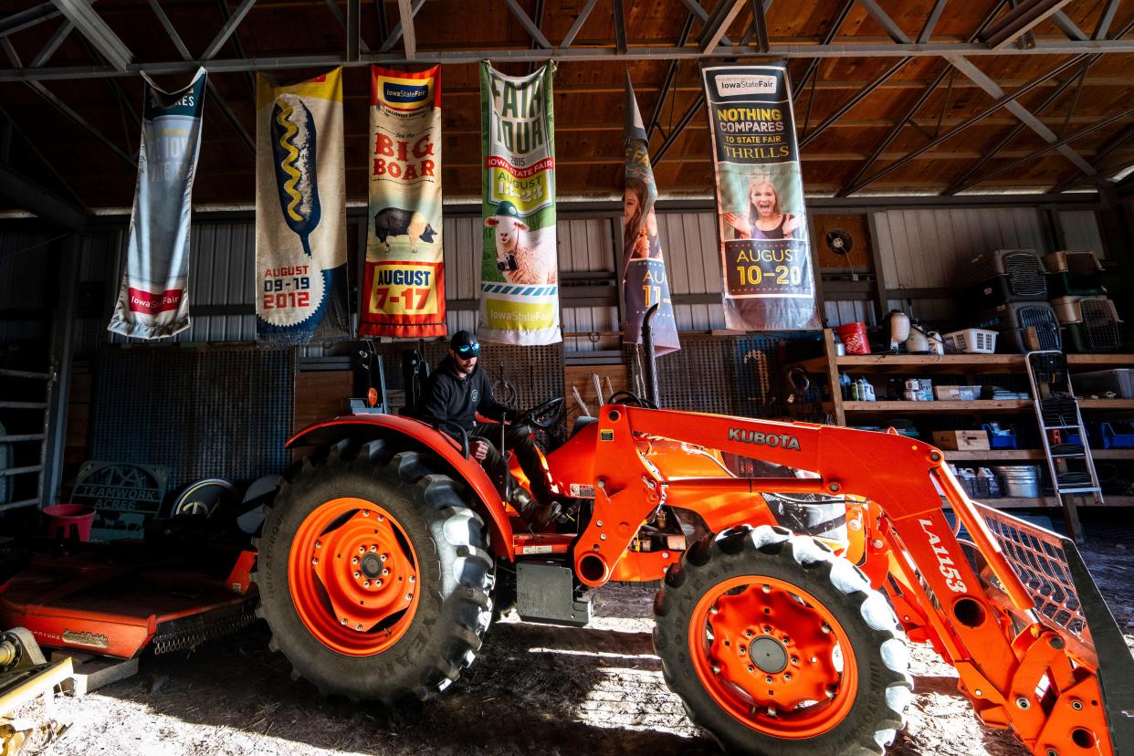 Farm manager Sam Applegate operates a tractor at In Harmony farm on Nov. 30, 2023, in Earlham.