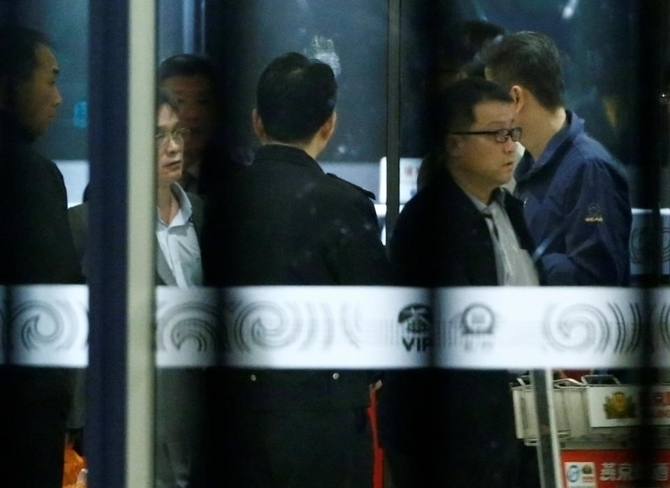 North Korean officials gather at the VIP exit at Beijing airport after the arrival of the MH360 flight from Malaysia, in Beijing, China March 30, 2017. REUTERS/Thomas Peter