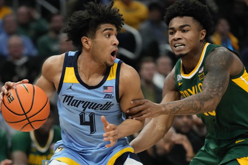 Marquette's Stevie Mitchell tries to get past Baylor's Langston Love during the first half of an NCAA basketball game Tuesday, Nov. 29, 2022, in Milwaukee. (AP Photo/Morry Gash)