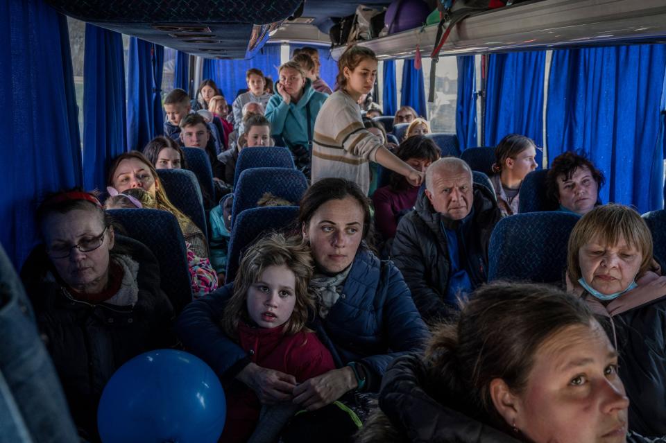 Ukrainian evacuees stand on a bus carrying refugees, after crossing the Ukrainian border with Poland at the Medyka border crossing, southeastern Poland, on March 28, 2022, following the Russian military invasion on Ukraine. - More than 3,8 million people have fled Ukraine since Russia's invasion a month ago, UN figures showed on March 28, but the flow of refugees has slowed down markedly. (Photo by Angelos Tzortzinis / AFP) (Photo by ANGELOS TZORTZINIS/AFP via Getty Images)