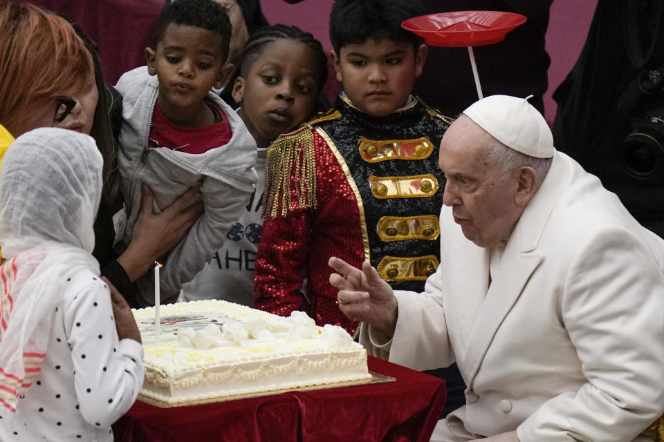 Pope Francis blows a candle on a cake as he celebrates his birthday with children assisted by the Santa Marta dispensary during an audience in the Paul VI Hall, at the Vatican, Sunday, Dec. 17, 2023. Pope Francis turnes 87 on Dec.17. (AP Photo/Alessandra Tarantino)