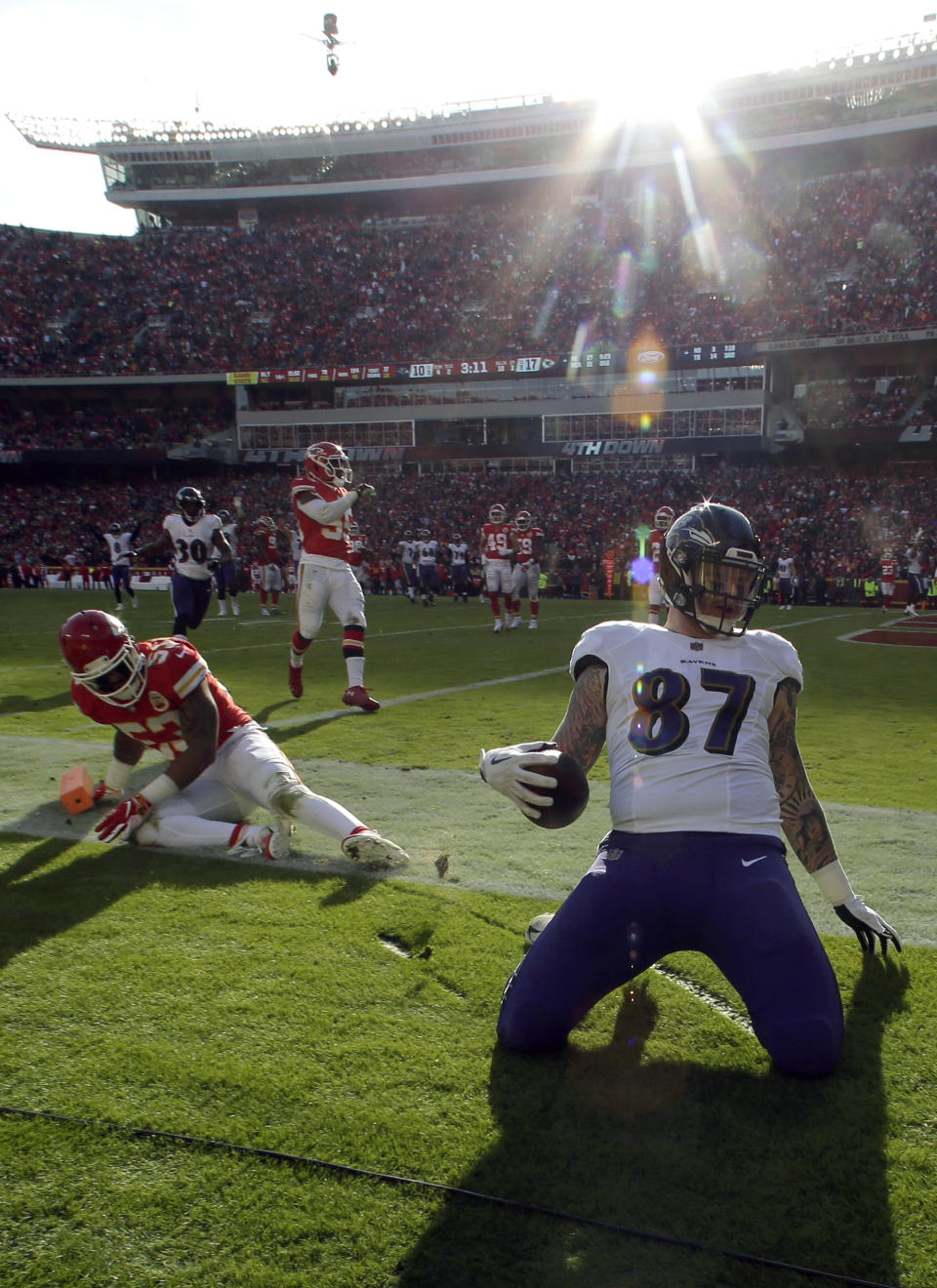 Baltimore Ravens tight end Maxx Williams (87) scores a touchdown past Kansas City Chiefs linebacker Anthony Hitchens (53) during the second half of an NFL football game in Kansas City, Mo., Sunday, Dec. 9, 2018. (AP Photo/Charlie Riedel)