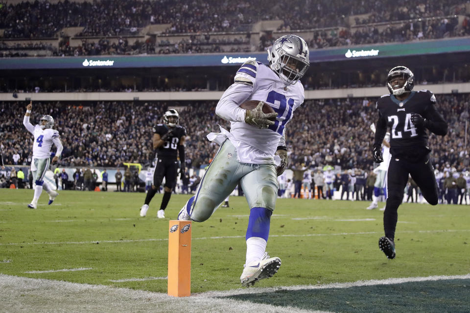 Dallas Cowboys running back Ezekiel Elliott (21) scores on a touchdown pass from quarterback Dak Prescott (4) as Philadelphia Eagles free safety Corey Graham (24) tries to stop him during the second half of an NFL football game, Sunday, Nov. 11, 2018, in Philadelphia. (AP Photo/Matt Slocum)