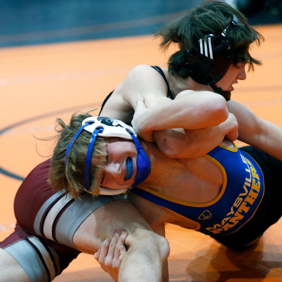 Maysville freshman D.J. Waite tries to work a move on John Glenn's Kris Wise during the consolation semifinals at the 32-team Jimmy Wood Invitational on Saturday at New Lexington High School.