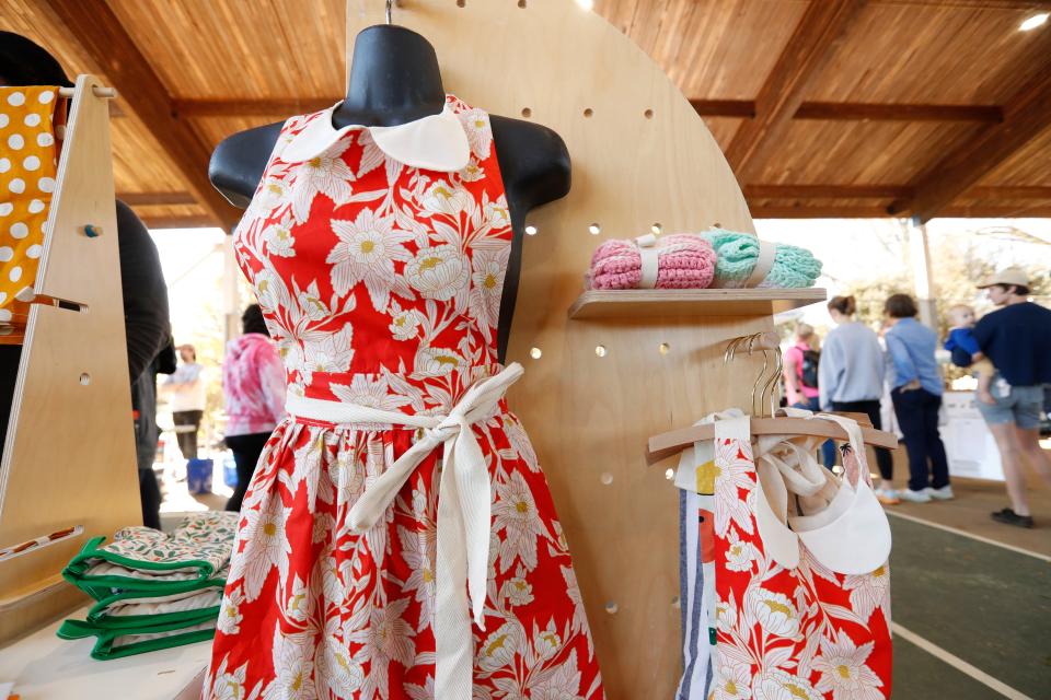 FILE - Handmade aprons and other crafts from Textile & Twine at opening day of the spring Athens Farmers Market at Bishop Park in Athens, Ga., on Saturday, March 4, 2023. The spring market is held every weekend at Bishop Park and at Creature Comforts on Wednesdays.