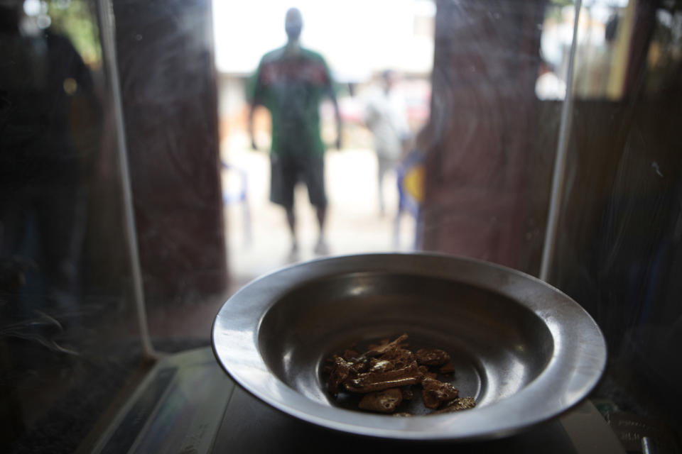 FILE - In this May 20, 2011, file photo, gold is weighed at a gold-buying store in Puerto Maldonado, Madre de Dios, Peru. Government efforts to halt illegal mining have mostly been futile. The clock has run out for an estimated 40,000 illegal gold miners who had until Saturday to legalize their status in a region of southeastern Peru where fortune-seekers have ravaged rainforests and contaminated rivers. (AP Photo/Esteban Felix, File)