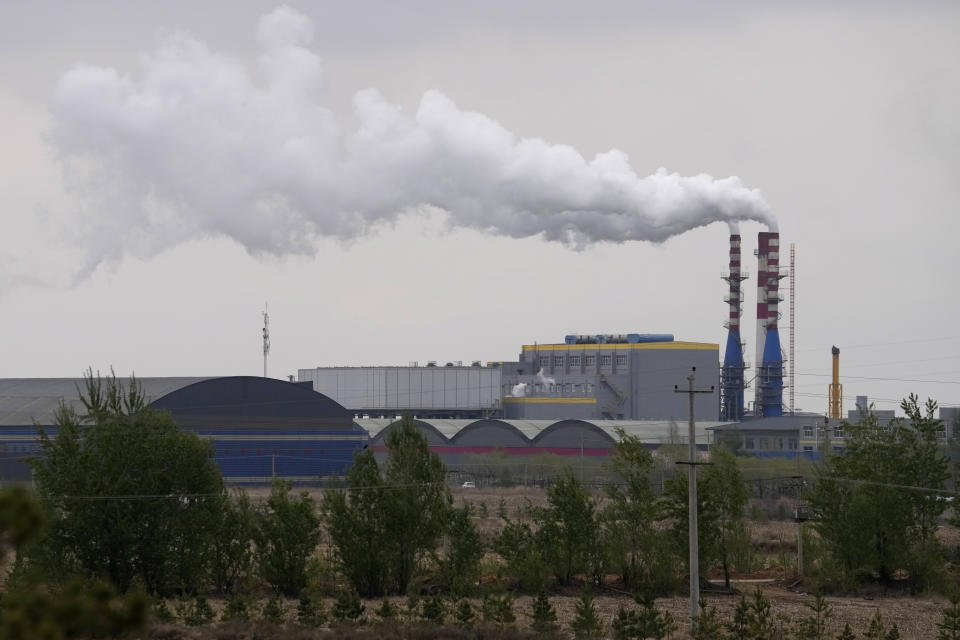 Smoking chimneys are seen along a highway in a coal producing region in Yulin in northwestern China's Shaanxi province, April 24, 2023. Energy security concerns, worsened by the war in Ukraine, and policy support from rich countries are likely to help investments in clean energy outpace spending on fossil fuels, the International Energy Agency said in a report issued Thursday, May 25, 2023. (AP Photo/Ng Han Guan)