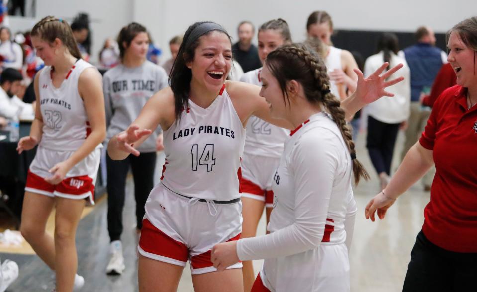 Lubbock-Cooper’s Gabby Contreras (14) and Peyton North (5) celebrate their win over Monterey in a District 4-5A game Friday, Dec. 16, 2022 at Lubbock-Cooper High School in Woodrow, Texas.