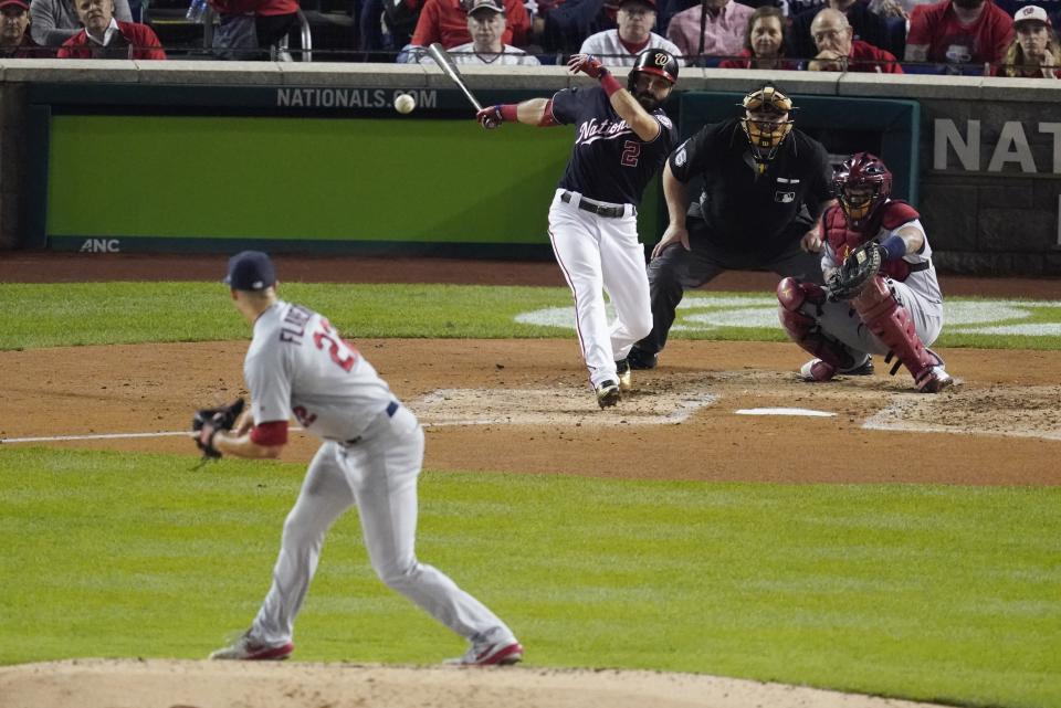 FILE - Washington Nationals' Adam Eaton hits an RBI single off St. Louis Cardinals starting pitcher Jack Flaherty during the third inning of Game 3 of the baseball National League Championship Series in Washington, in this Monday, Oct. 14, 2019, file photo. MLB will experiment with a 12-inch greater distance between the mound and home plate during a portion of the Atlantic League season in an effort to decrease strikeouts and increase offense. The pitching rubber will be moved back to 61 feet, 6 inches starting Aug. 3. (AP Photo/Alex Brandon, File)