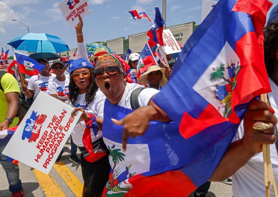 Demonstrators wave flags and chant words of support on Sunday in North Miami, joining Haitians across the United States and the world in a march to bring awareness to the escalating violence in the Caribbean country.