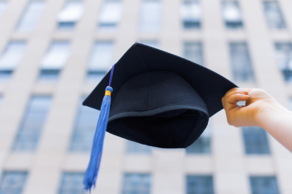 graduation cap with university building