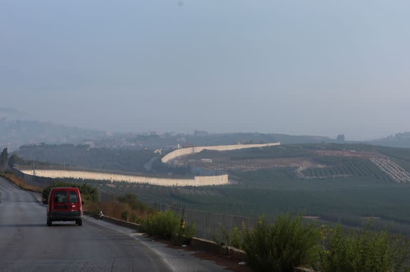 A vehicle drives in Kfar Kila village near the border with Israel, southern Lebanon