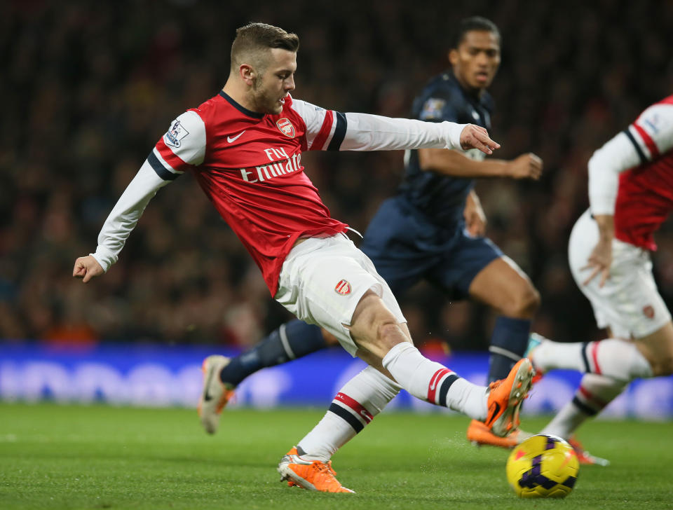 Arsenal's Jack Wilshere takes a shot at goal during their English Premier League soccer match between Arsenal and Manchester United at the Emirates stadium in London, Wednesday, Feb. 12, 2014. (AP Photo/Alastair Grant)