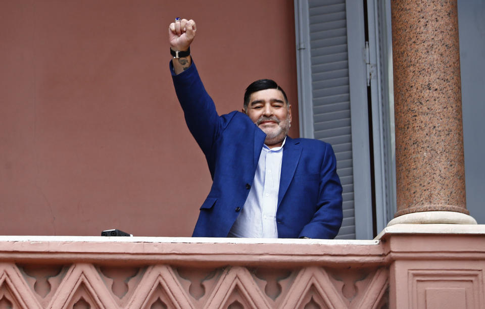FILE - Former soccer great Diego Maradona acknowledges fans below at the Casa Rosada government house after his meeting with Argentine President Alberto Fernandez in Buenos Aires, Argentina, Thursday, Dec. 26, 2019. A medical examiner's report into the death of Maradona injected uncertainty Monday, April 29, 2024, into a case of criminal negligence brought against eight medical workers involved in his care, raising new questions just a month before the staffers are set to stand trial for homicide. (AP Photo/Marcos Brindicci, File)