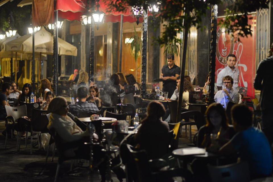 Egyptians relax outside a cafe in Cairo, Egypt, Wednesday, Oct. 31, 2012. Egypt’s capital prides itself on being city that never sleeps, with crowds filling cafes and shops open into the small hours. So the government is facing a backlash from businesses and the public as it vows to impose new nationwide rules closing stores and restaurants early. Officials say the crisis-ridden nation has to conserve electricity, but they also seem intent on taming a population they see as too unruly. (AP Photo)