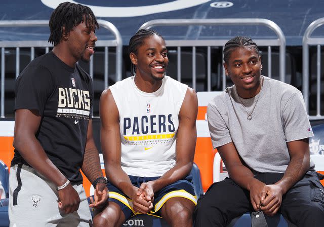 Ron Hoskins/NBAE/Getty Justin Holiday #8, Aaron Holiday #3 and Jrue Holiday #21 of the Milwaukee Bucks sitting together.