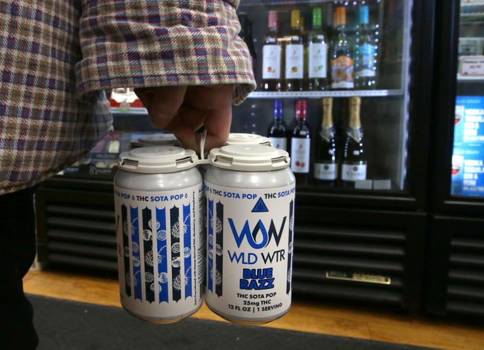 A John's Grocery customer holds WLD WTR THC-infused soda in the checkout line Friday, Jan. 19, 2024 in Iowa City, Iowa.