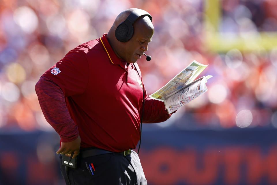 Offensive coordinator Eric Bieniemy of the Washington Commanders looks at his play calling sheet. (Photo by Justin Edmonds/Getty Images)