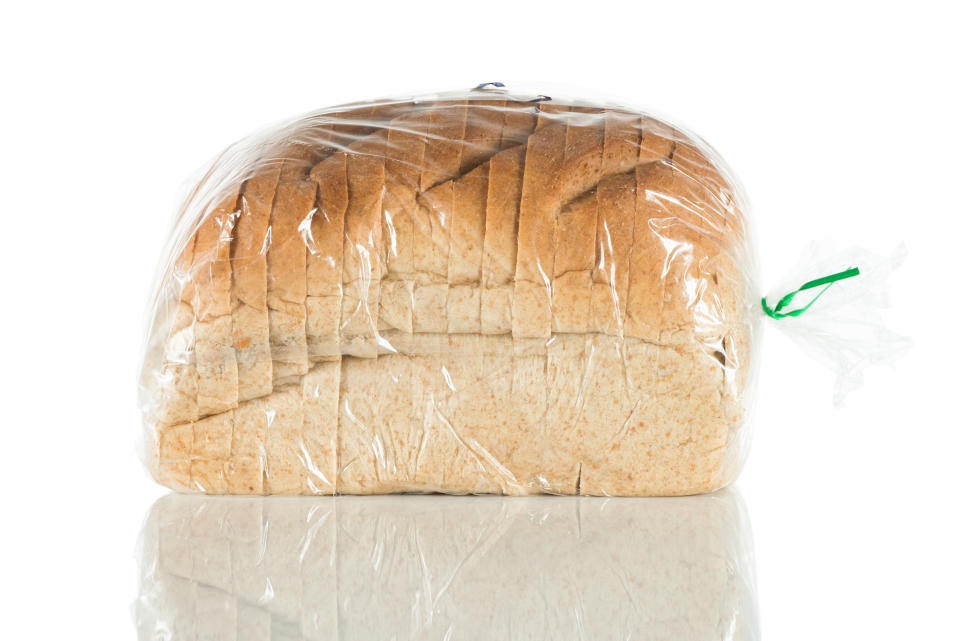 brown sliced bread in a clear package against a white background