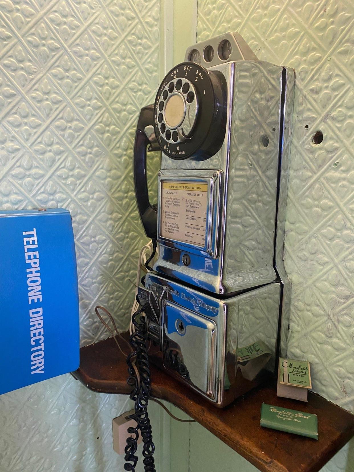 It's not often you can find a pay phone these days. This phone was in the Leland Hotel in 1976. Classic car collector Johnny Matthes now owns it and has restored the 1927 phone booth that used to be in the hotel's lobby. It is part of his mini museum on Ashland Road.