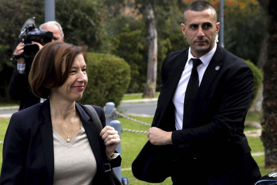 France's Defense Minister Florence Parly, left, arrives at the Presidential Palace for talks with Cypriot President Nicos Anastasiades in capital Nicosia, Cyprus, Tuesday, Feb. 18, 2020. Parly said on Tuesday that her country stands in solidarity with Cyprus amid tensions over a Turkish search for natural gas inside Cypriot waters. (AP Photo/Petros Karadjias)