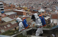 FILE - In this April 28, 2020, file photo, city workers disinfect a stairway in attempt to help contain the spread of the new coronavirus, in La Paz, Bolivia. Even amid a global pandemic, there’s no sign that corruption is slowing down in Latin America. Perhaps the biggest case is in Bolivia, where the health minister was arrested amid allegations that officials bought 170 ventilators at inflated prices. (AP Photo/Juan Karita, File)