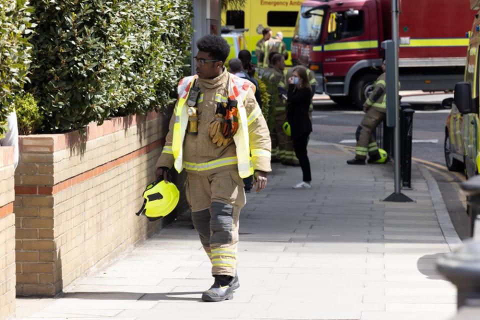 Firemen at the scene in the aftermath.