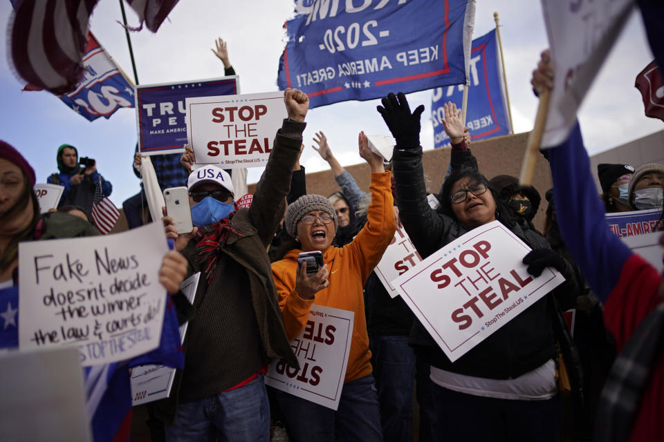 Supporters of President Donald Trump pray as they protest the election outside of the Clark County Election Department, Sunday, Nov. 8, 2020, in North Las Vegas. (AP Photo/John Locher)