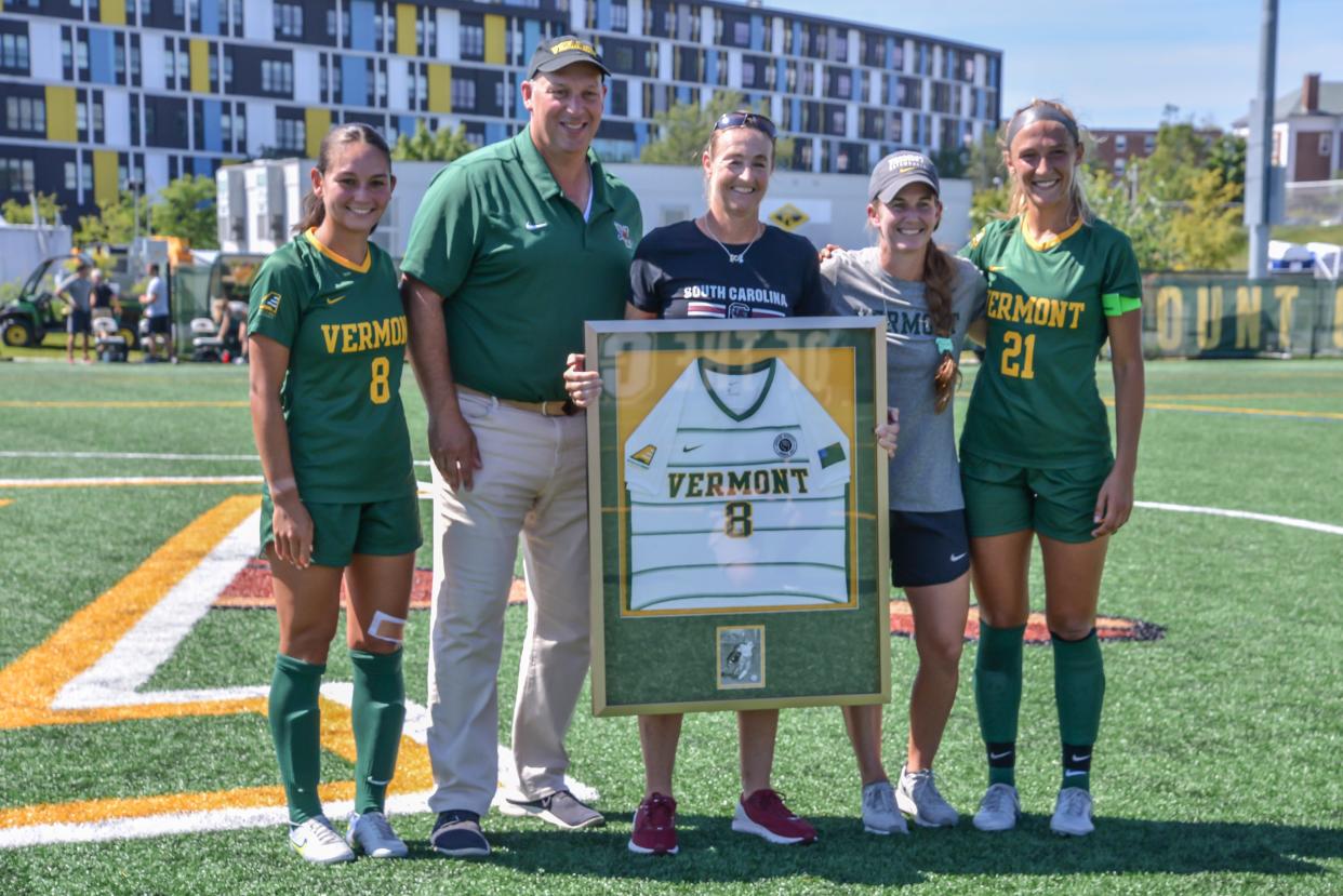 University of South Carolina's women's soccer coach Shelley Smith (center) is celebrated for her contribution to UVM program when she was a student-athlete prior to their game vs the UVM Catamounts at Virtue Field in 2022.