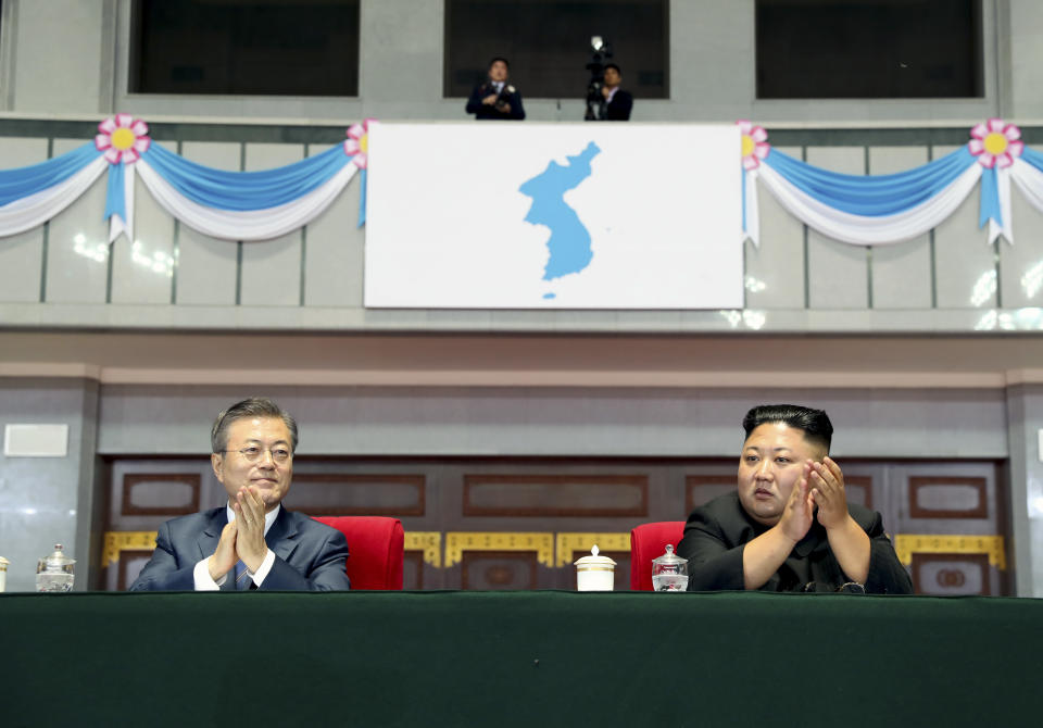 In this Wednesday, Sept. 19, 2018 photo, South Korean President Moon Jae-in, left, and North Korean leader Kim Jong Un watch the mass games performance of "The Glorious Country" at May Day Stadium in Pyongyang, North Korea. President Moon Jae-in has delivered a speech to a massive North Korean crowd gathered for mass games, calling for the rival Koreas to end seven decades of hostility and build a future of peace and prosperity. (Pyongyang Press Corps Pool via AP)